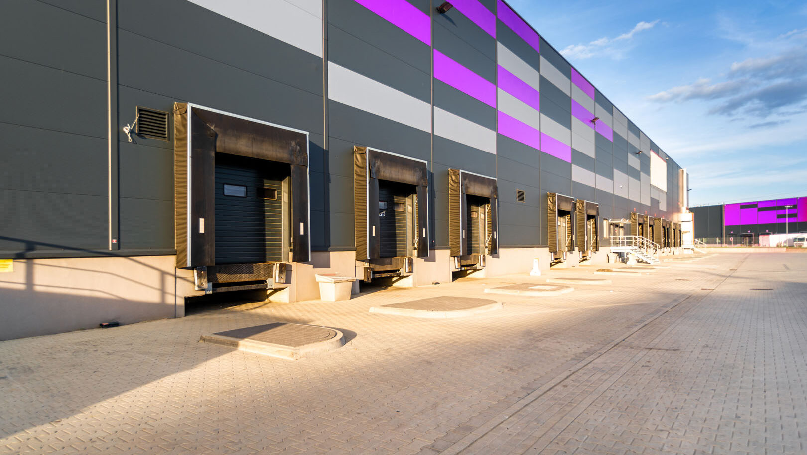 Cargo loading dock doors of big warehouse building, outdoor